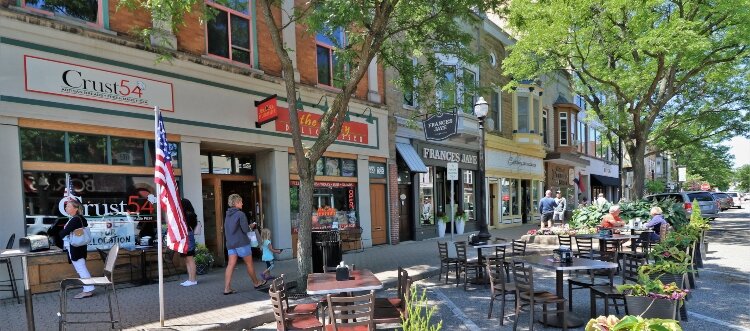 Restaurants in downtown Holland transform parking spaces into areas for patio seating.