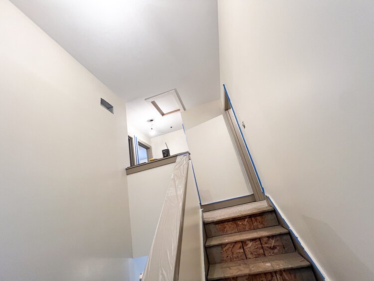 Thoughtful design went into the creation of each unit, where community-inspired elements, like this inviting open stairway, beckon visitors to explore the second floor, where three bedrooms and a bathroom await a future homeowner.