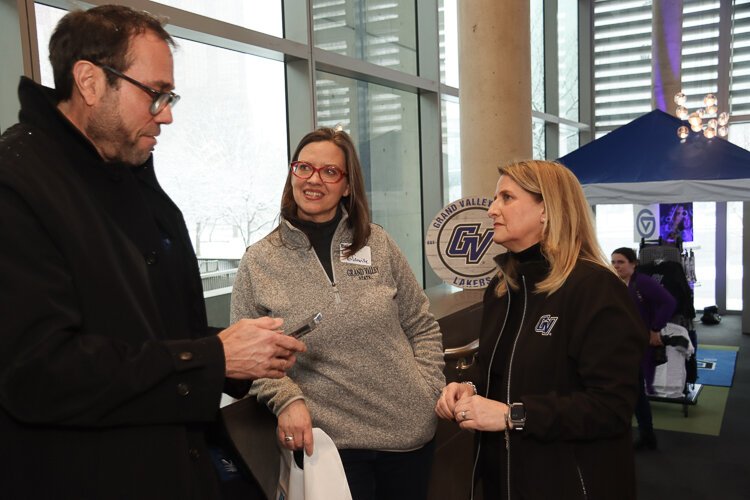 Kent County Commissioner Tony Baker, State Rep. Carol Glanville (84th House) and GVSU's Vice President & Chief Public Relations and Communications Officer Stacie Behler converse outside the new Laker Store.