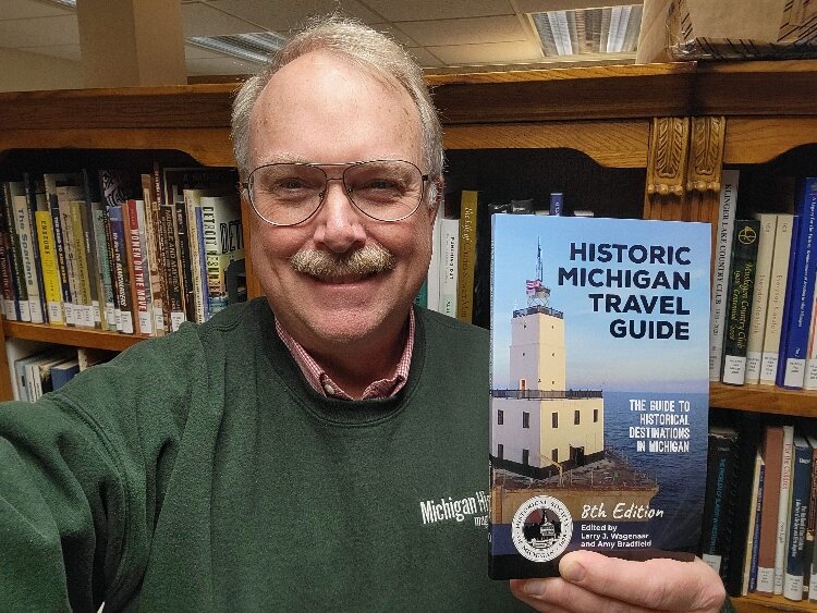 Historical Society of Michigan Larry J. Wagenaar with the new edition of the Historic Michigan Travel Guide.