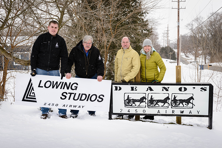 David and Matthew Lowing install new signage for the expansion of Lowing Studios with pervious owners of Deano’s Studios, Dean Horn and Rene Anderson