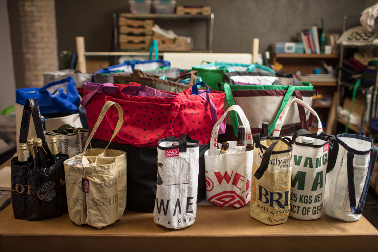 Discarded materials from brewing become transformed into useful bags.