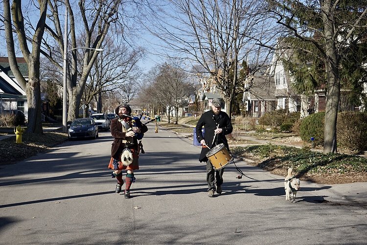 Jesse on bagpipes and his pal on the drum parade the streets of Eastown bringing joy to homebound neighbors. 