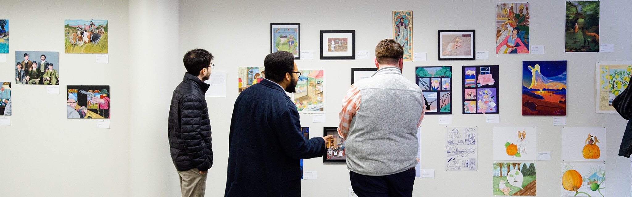 Viewers exploring the Annual Student Exhibition at Kendall College of Art and Design.