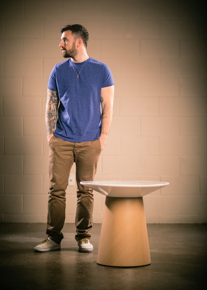 Chuck Anderson with the table he designed for Turnstone.