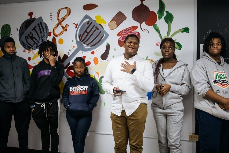 Youth from ECN's Teen Advisory Council stand by the Vault kitchen's new mutal.