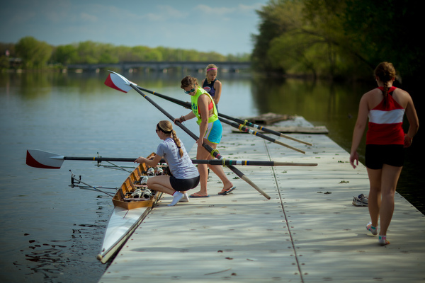 Students get into a shell on the Grand River to practice rowing.