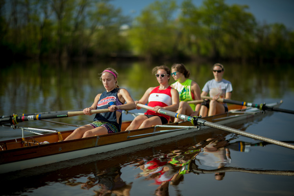 Students row on the Grand River.