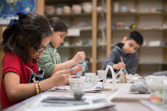 Deisy Cano paints pottery during an art class.