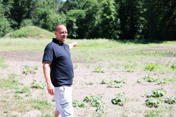 Lee Township-based community health worker Jerry Burton shows off a community garden he established for local residents.