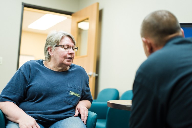Lee Township resident Judy Wirtz confers with community health worker Jerry Burton.