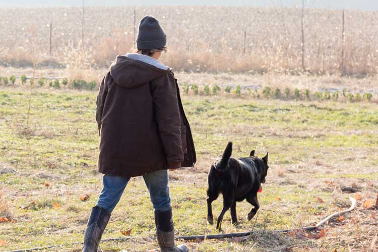Farmer Kelly Vellelunga and her dog, Marla.