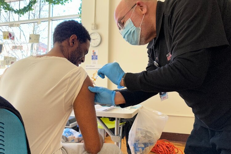 A man received COVID vaccination at DRM clinic in Grand Rapids. 