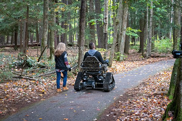 Visitors can use track chairs to explore the trail at Hartwick Pines State Park in Grayling.  (MDNR)