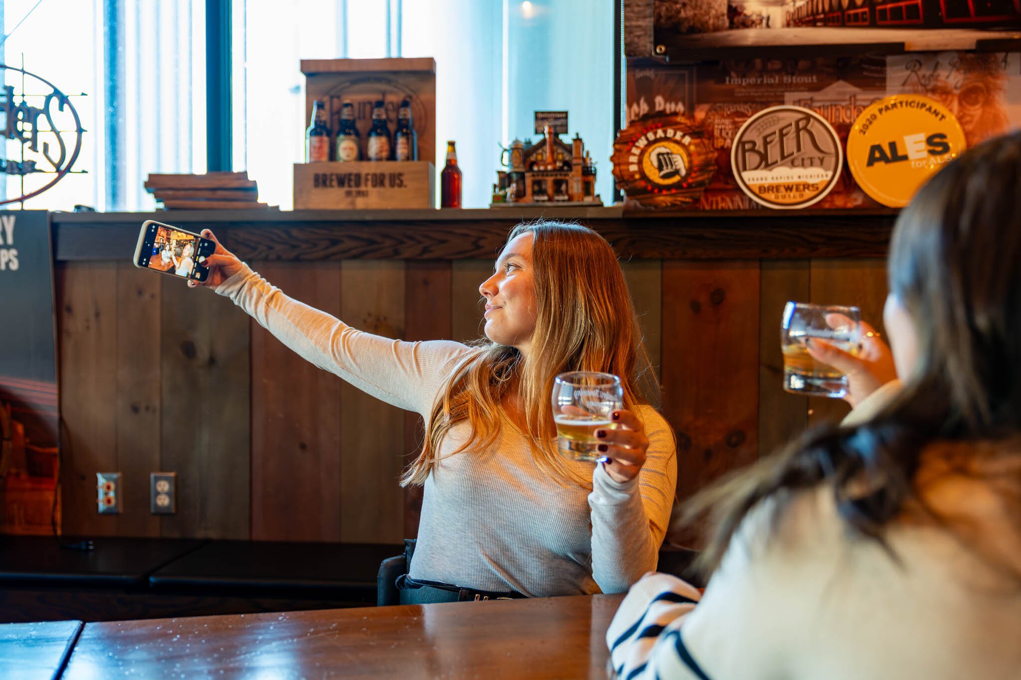 Influencers and friends Stefanie Schaffer and Erika Nala Franco take a selfie at Founders Brewing Co.