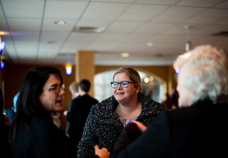 Michelle Rhodes, associate vice president for financial aid at GVSU, chats with colleagues.