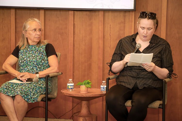 Cheryl Youngquist (left) from Love in Action listens to Amanda Volz (right), a neighbor who has used the Lakeshore's food pantry with her family.