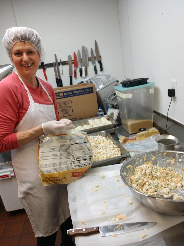 Carmen VanHaitsma volunteers in the kitchen of the homeless shelter, Family Hope Center.