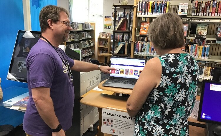 Clyde Waltenbaugh demonstrating how to use one of KDL's public computers.