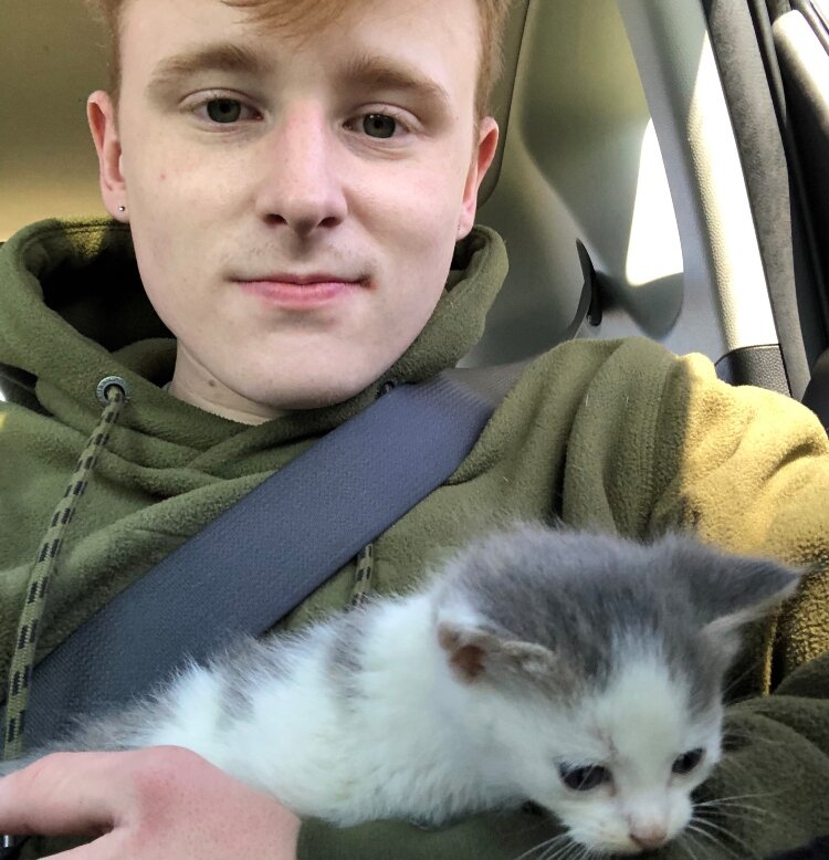 Connor DenBleyker with his new kitten, Elmer.