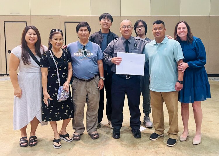Ethan Lien’s dad surrounded by family after graduating from the correctional officer academy in 2024.