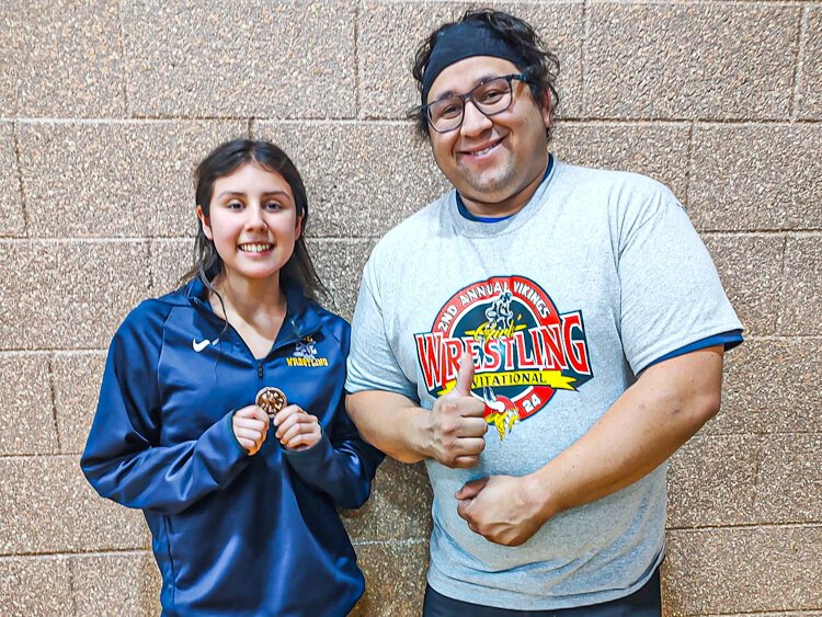 Lee High School student poses with their coach. 