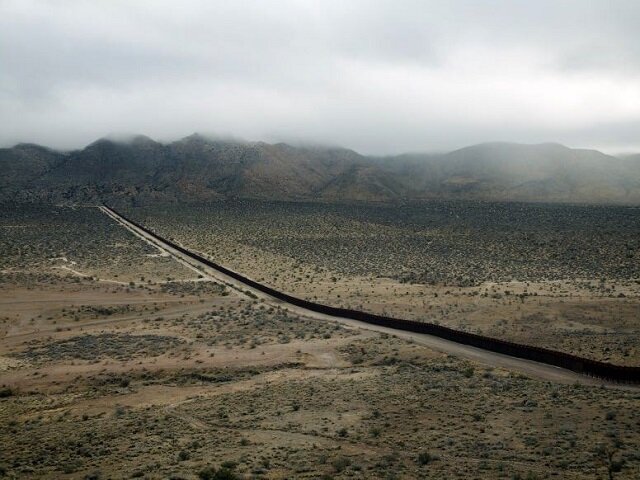 A photo in the “Border Cantos | Sonic Border" exhibit shows a fence erected on the Mexican border. 