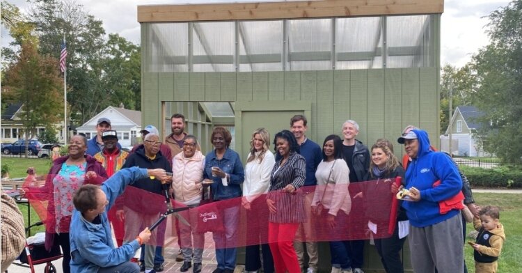 The ribbon cutting of a 2023 project As a collaborative project with students from the KCAD Urban Collaborative Studio, AARP and Dwelling Place of Grand Rapids.