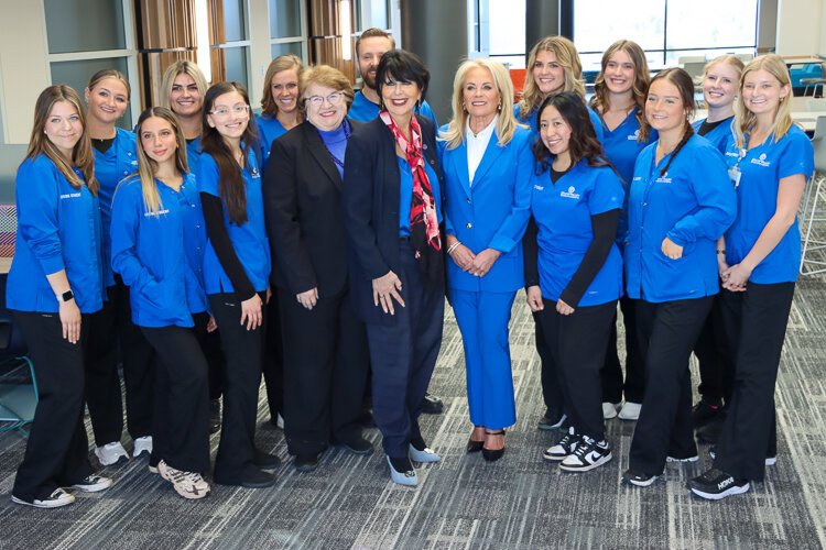 Dean Linda Lewandowski, GVSU President Philomena V. Mantella, and Pamella DeVos are surrounded by aspiring nurses from the Kirkhof College of Nursing, all of whom have received job offers.