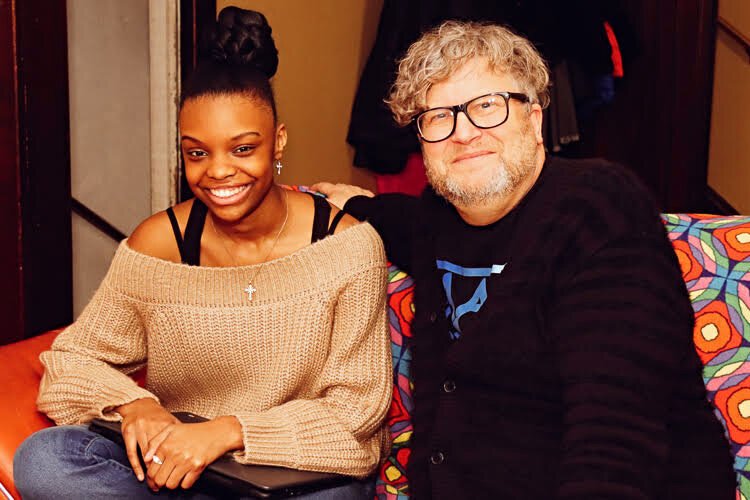 Voices of Youth participant Mazonnah Holiday poses with Rapid Growth Publisher Tommy Allen in her home.