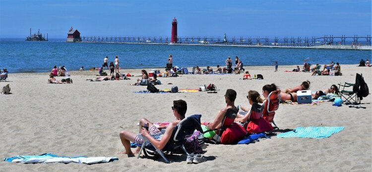Memorial Day visitors to Grand Haven State Park practice safe social distancing.