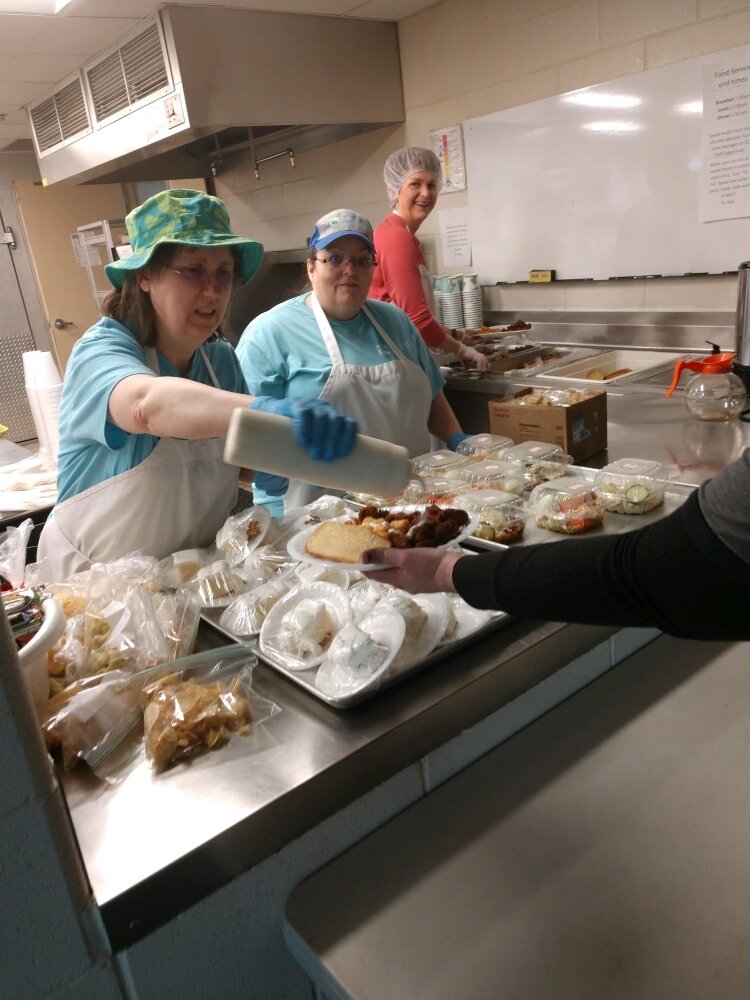 Tina Paul (left) and Nancy Leach, who work in the Holland Rescue Mission's Gateway Store have been "redeployed" serve food at Family Hope Ministry Center.