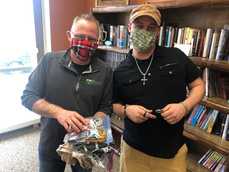 Holland Rescue Mission staff Aaron Paul and Lonny Young show off donated reusable cloth masks that will help keep staff, volunteers and residents at the shelter safe.