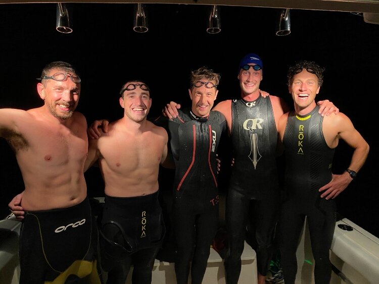 The 'Epic Swim' team practices a night swim on Lake Michigan. Pictured from left to right are Nick Hobson, Todd Suttor, Matt Smith, Jon Ornée and Jeremy Sall. (Missing from the photo is team member Dave Ornée.)