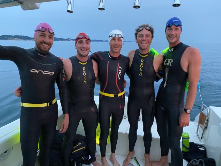 The 'Epic Swim' team practices a night swim on Lake Michigan. Pictured from left to right are Nick Hobson, Todd Suttor, Matt Smith, Jon Ornée and Jeremy Sall. (Missing from the photo is team member Dave Ornée.)