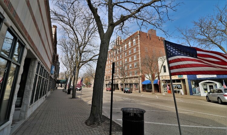 The typical one-way stream of vehicle traffic on a Saturday in downtown Holland has faded away.