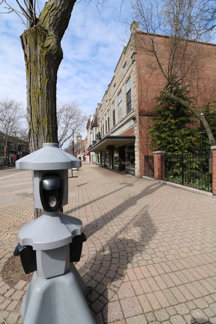 Hand-sanitizing stations in downtown Holland stand as sentries against the dreaded coronavirus.