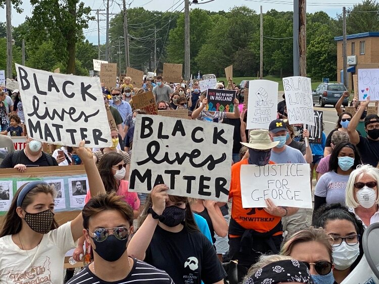 Protestors walk along Douglas Avenue to the Unity Bridge.