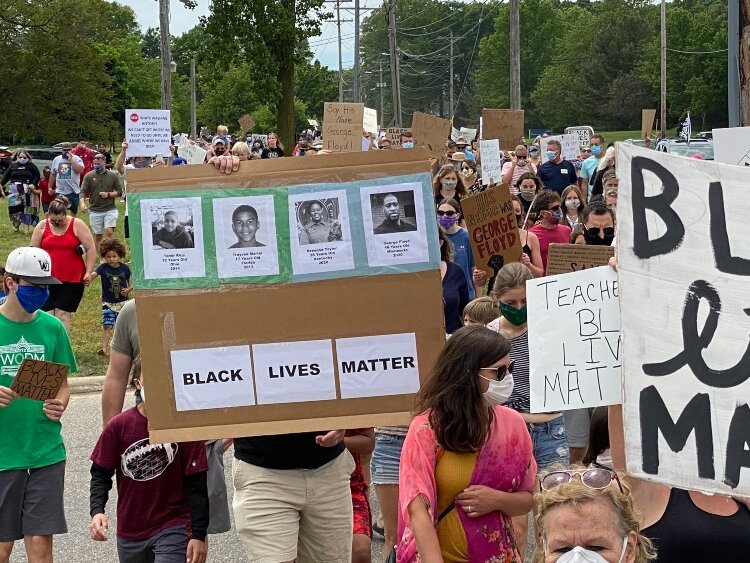 Protesters carried signs about the African American victims of police brutality. 