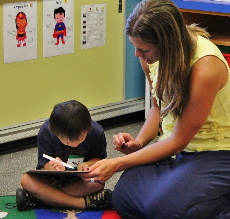 A teacher works with a student as part of the Ready for School program. 