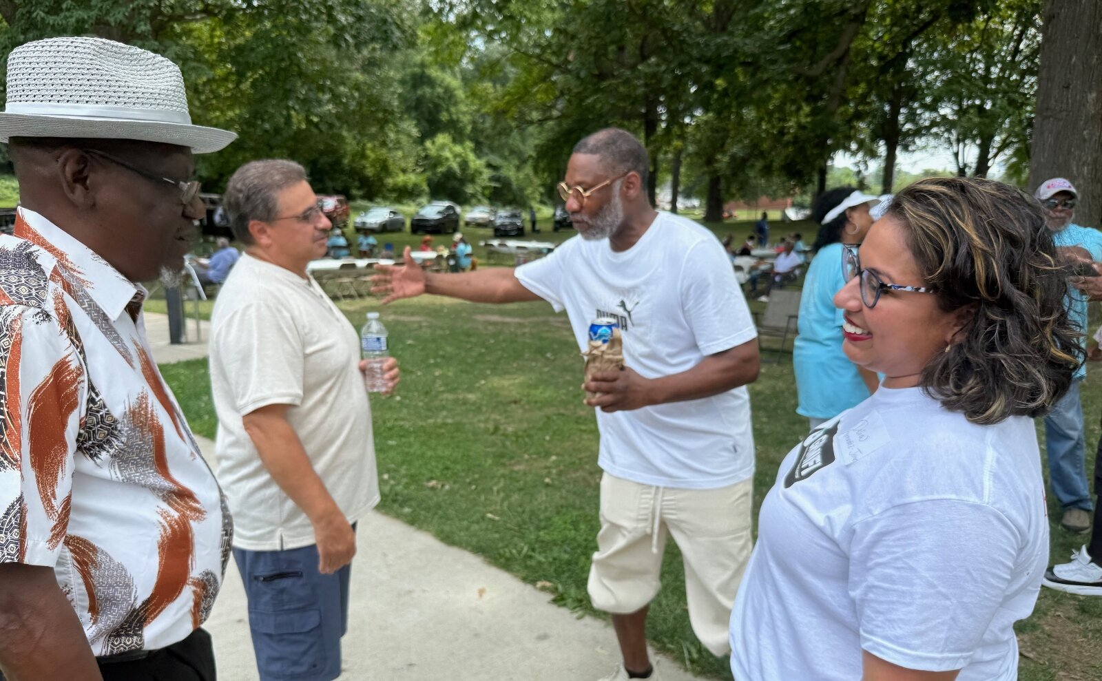 Delia Fernández-Jones, a historian at Michigan State University, talks an attendee of the GR West Side reunion. 