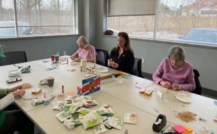 KDL volunteers prepare the seed packets for the library's Seed Library.