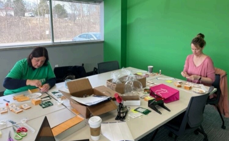 Volunteers prepare the seed packets for KDL's Seed Library. 
