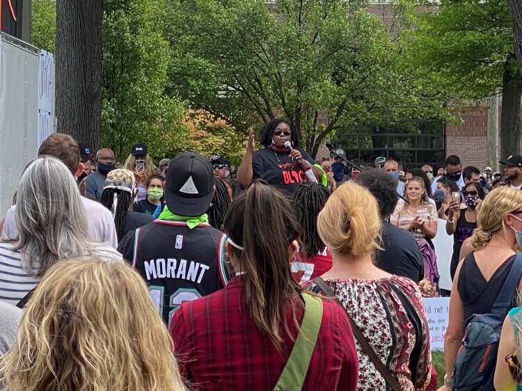 Shutaveya Ward speaks to the crowd during a rally before the march. 