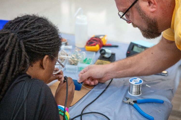 Students explore hands-on exhibits and the latest tech from different companies at the Tech Showcase, an annual featured event of Tech Week GR hosted by The Right Place.