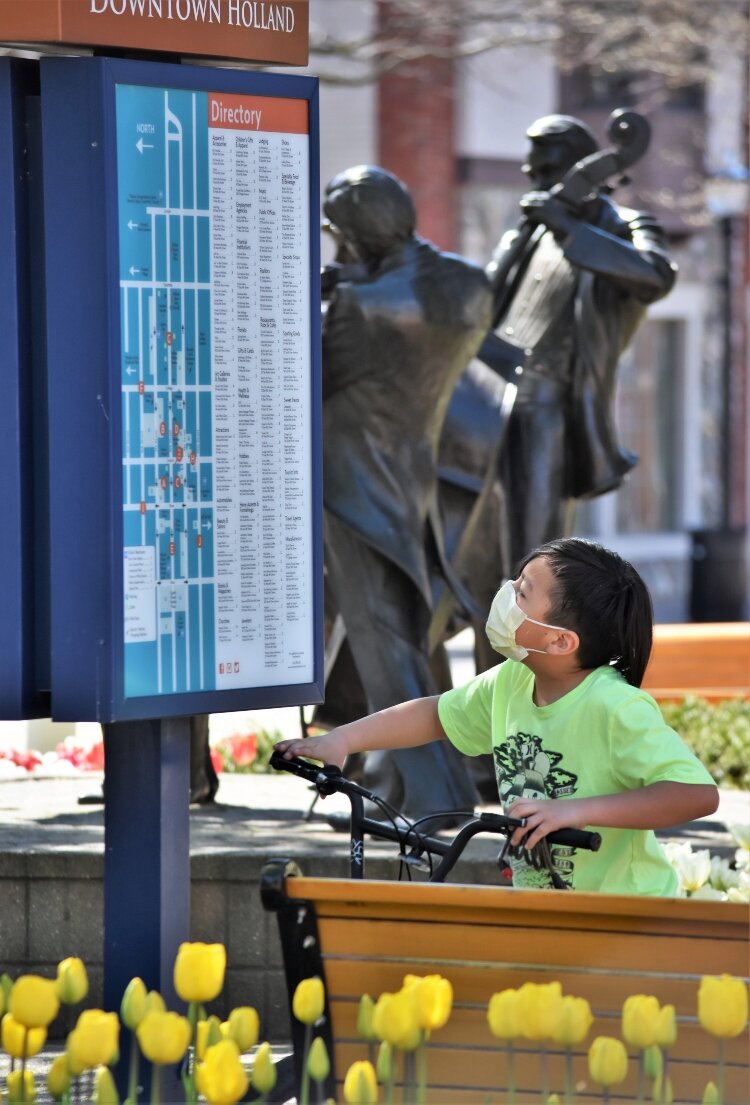 Seeking direction, this young biker was among the relatively few visitors to downtown Holland during the first Sunday of festival week.