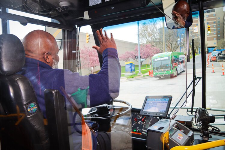 Monroe O'Bryant practices driver etiquette, exchanging waves with fellow drivers on the street.