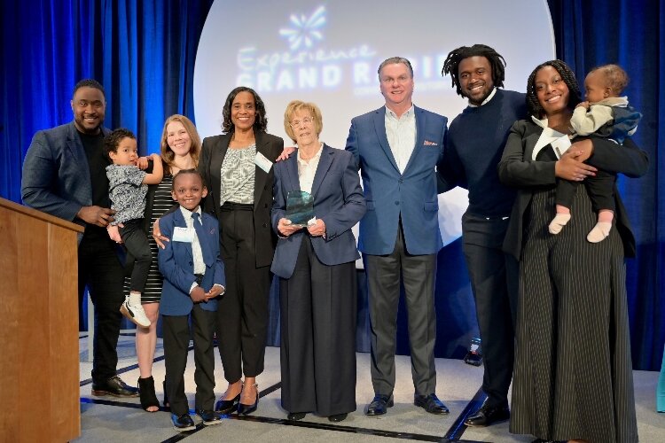 Kayem Dunn receives her award with the family of the late Floyd Wilson Jr and Doug Small. 