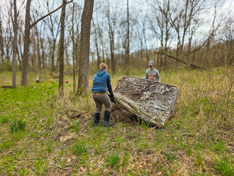  Backcountry Hunters & Anglers' Shawn Helms' teenage son joins others at the at 2025 Barry State Game Area cleanup.
