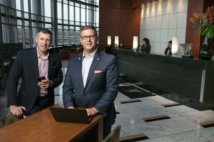 Josh Serba, left, and Brian Behler, right, of JW Marriott use technology to make a better hotel. 